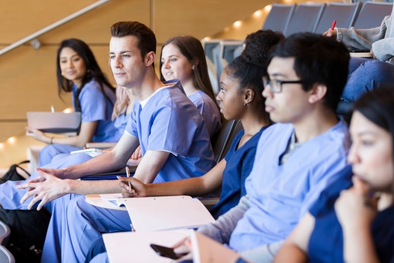 diverse group of medical students attending a class in an auditorium