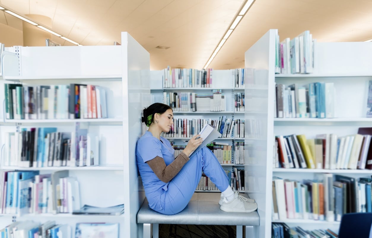 Female intern finds quiet spot in library to study