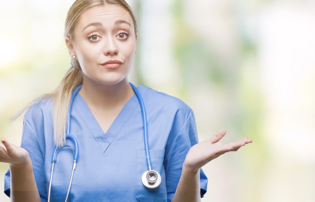 Young blonde surgeon doctor woman over isolated background clueless and confused expression with arms and hands raised. Doubt concept.